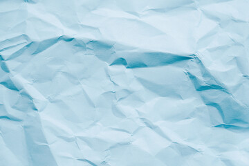 Crumpled sky blue paper texture.