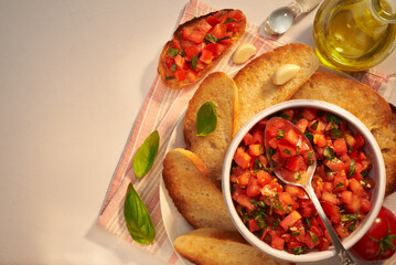 Classic bruschetta – healthy vegetarian Italian snack in a morning or evening light on a gray table. Top view photo with place for your text.