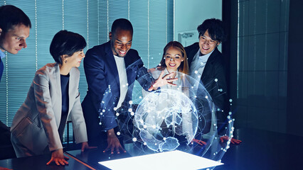 Multi racial group watching hologram of the earth in dark office. Global network.