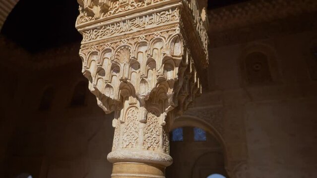 Alhambra palace in Granada, Andalusia, interior detail of marble pillar carving in moorish castle of Alhambra in Spain, famous tourist destination 