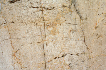 Granite texture with cracks and spots. Light yellow natural stone for bathroom decoration