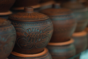 A row of handmade clay pots, selective focus