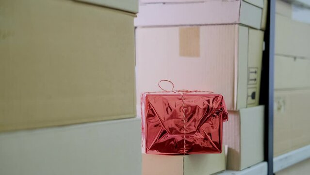 A man hand takes a gift box in the store warehouse for delivery on Christmas Eve on New Year Eve