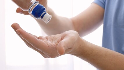 A sanitizer is poured onto the hand to treat infections, to prevent the spread of coronavirus...