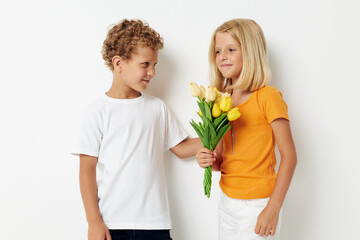 Boy and girl fun birthday gift surprise bouquet of flowers isolated background unaltered