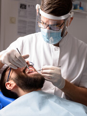 Dentist performs a regular examination of the patient