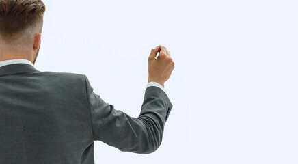 rear view.businessman writing on an invisible Board