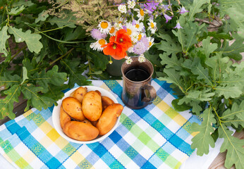 Latvia summer June 23-24. Traditional national Latvian food - cheese patties. The Ligo celebration in June decorates the house with a bouquet of wildflowers and oak branches. 