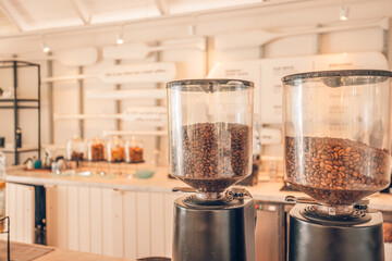 Closeup coffee beans with modern blur coffee shop interior background. Morning sunlight, start the day with positive vibes, happy moods