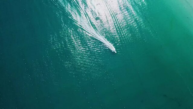 Tourists parasailing over sea coastline, drone point view. Aerial footage of people on parachute above tropical beach.