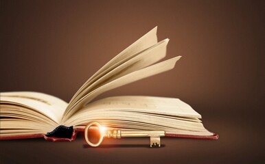 Retro open antique book on wooden table with vintage key