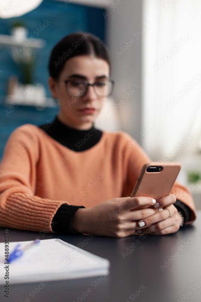 Aufkleber content creator holding smartphone looking at content on screen. student with glasses reading email 