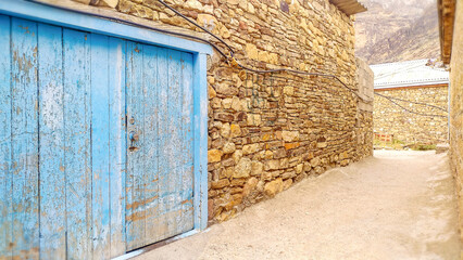 Blue gate on the street of the Dagestan village