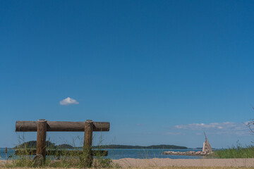 Fototapeta na wymiar Wooden bench on the seashore, on a sunny summer day.Finland.