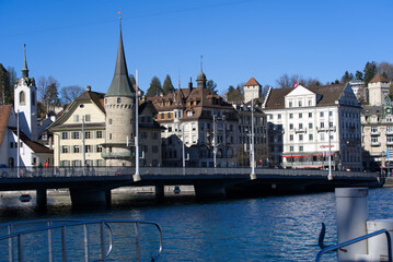 Fototapeta na wymiar Cityscape of Luzern with Lake Bridge and lake Lucerne in the foreground on a sunny winter day. Photo taken February 9th, 2022, Lucerne, Switzerland.