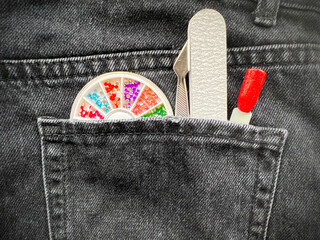 nail file in the back pocket of jeans. Tools for manicure nail master. Decor for nails. Sample of...