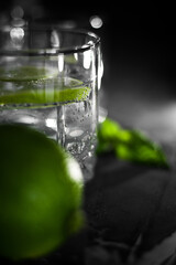 Close up view of a glass of crystal water with lime fruit slice