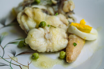 monkfish, fish in green sauce with asparagus, hard-boiled egg and peas