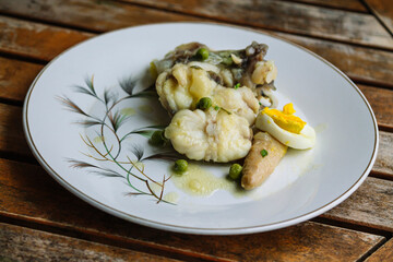 monkfish, fish in green sauce with asparagus, hard-boiled egg and peas