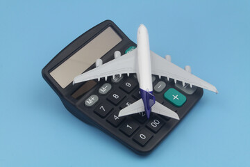 Airplane tickets price, travel budget, cost or expenses concept. Airplane model and calculator on...