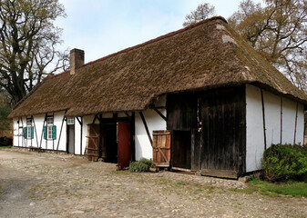 Fototapeta na wymiar ancient white farmhouse in a rural landscape, Bokrijk, Belgium