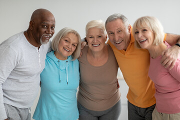 Multiracial group of athletic senior people posing together