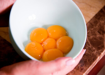 hand holding a bowl of eggs