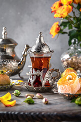 Fototapeta na wymiar Oriental sweets. Lukum, pistachio baklava. Fragrant tea. Turkish mood still life. For advertising, window dressing, travel posters and cafes.