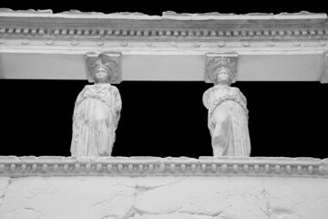 The Caryatid porch of the Erechtheion Temple in Athens isolated on black background with clipping...