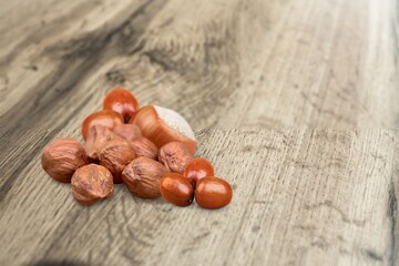 Roasted chestnuts, autumn food on a rustic wooden background