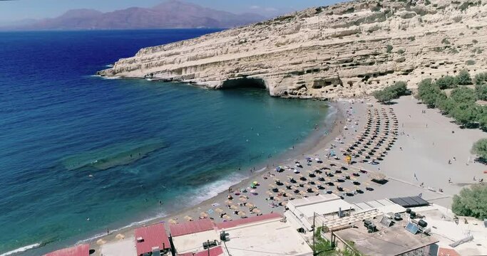 Beautiful view from a drone flying over the beach and bay in Matala Crete Greece