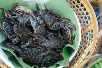 salted crab , black freshwater crabs are a staple in Asian cuisine on banana leaves and wooden baskets.