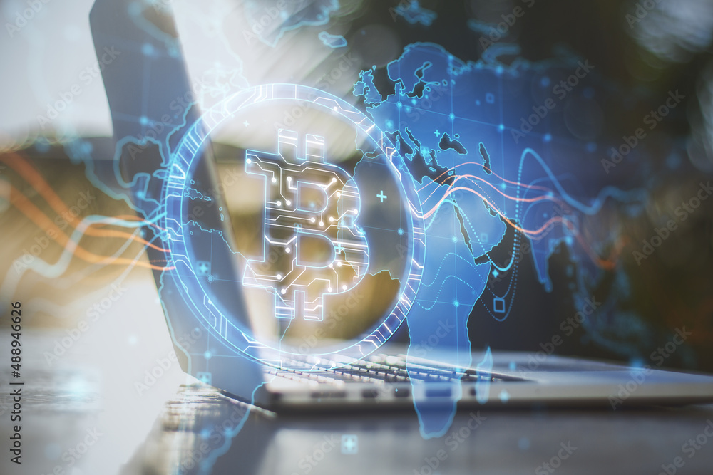 Poster close up of desktop with laptop and creative glowing global bitcoin hologram on blurry outdoor backg