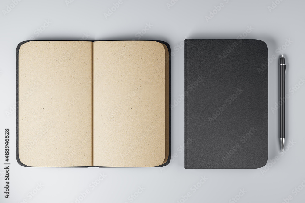 Poster top view on notebooks with black cover and blank beige pages and black pen near on light backdrop. 3