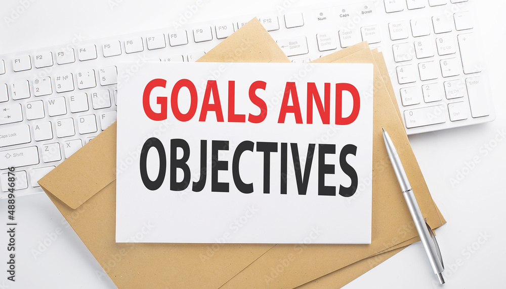 Poster text goals and objectives on the envelope on the keyboard