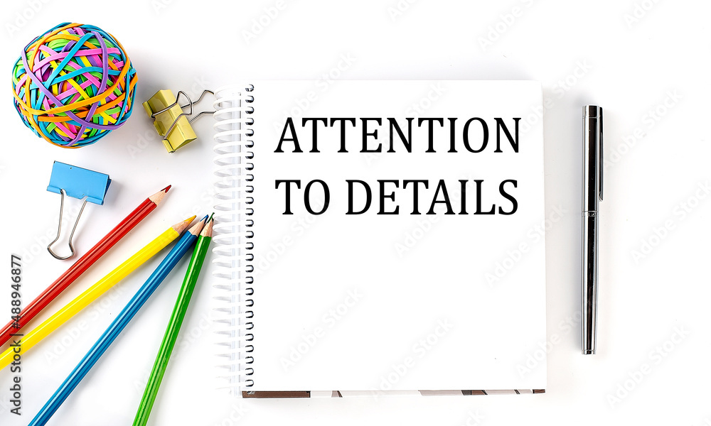 Poster notebook ,pencils,pen and rubber band with text attention to details on the white background