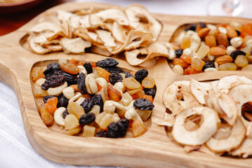 dried fruit and nuts on a wooden background
