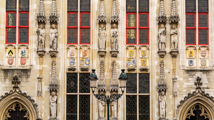 Fototapeta premium Architectural details of Bruges City Hall building in Burg square, Belgium