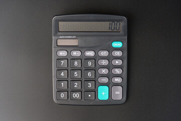 top view of a black calculator on a black