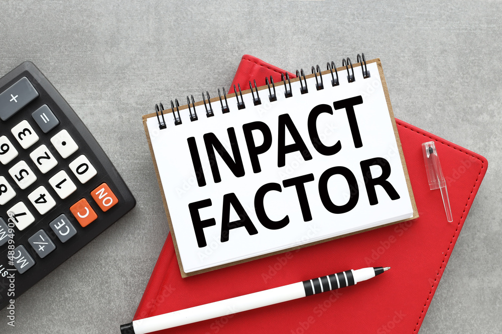 Poster impact factor text on open notepad near calculator. business concept