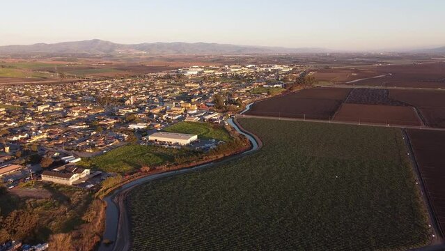 River divide iconic American town and endless farmland, aerial drone view