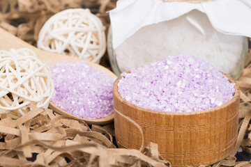 Fototapeta na wymiar lilac relaxing bath salt in a wooden bowl close-up