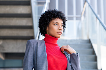 An elegant African American woman with short hair in an office building