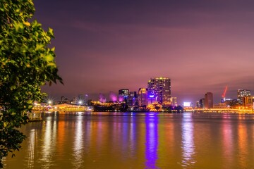 Fototapeta na wymiar Enjoy the Nha Rong wharf and Ben Nghe canal afternoon in Ho Chi Minh City (Saigon). Colorful Saigon river at night.