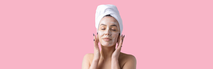 Beauty portrait of woman in white towel on head applies cream to the face. Skincare cleansing eco...