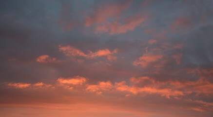 Naklejka na ściany i meble sunset scenery, grey sky with pink lighted clouds