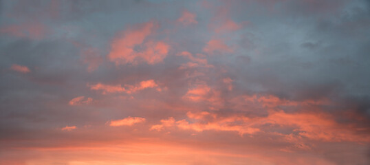 Naklejka na ściany i meble dreamy sunset scenery, grey and blue sky with pink lighted clouds