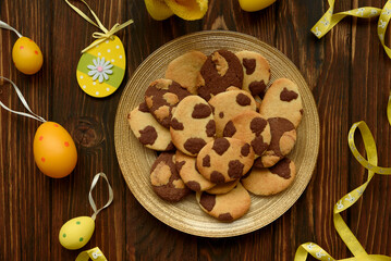 Beautiful Easter egg shaped cookies on wooden table