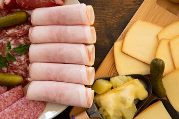 plate of charcuterie cheese for a raw and fondue raclette on a table