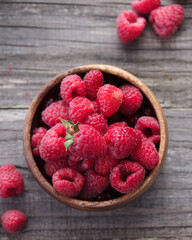 Fresh raspberry in a wooden bowl